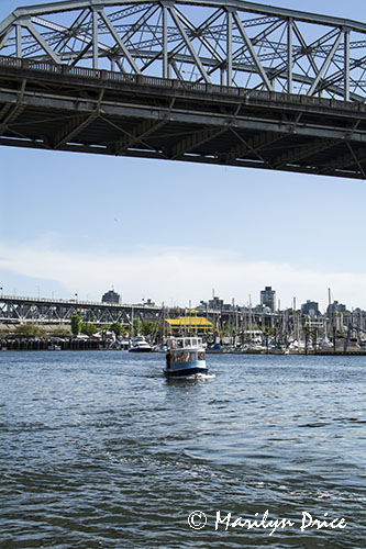 False Creek Ferry passes under a bridge, Vancouver, BC