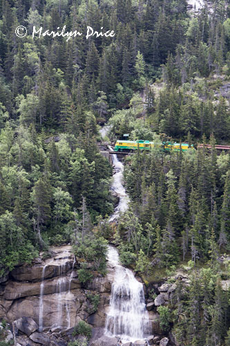 White Pass train crosses the bridge over Pitchfork Falls, on the road to White Pass, Skagway, AK