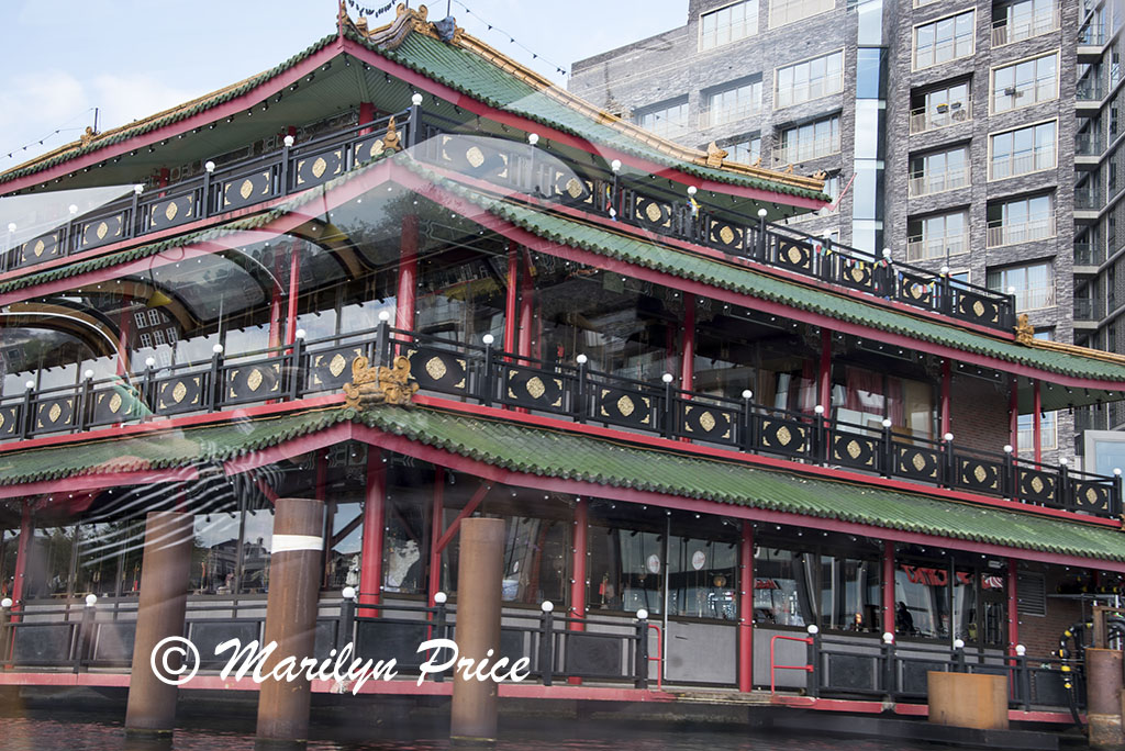 Floating Chinese restaurant seen on the canal cruise, Amsterdam, Netherlands