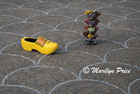 Oversized Dutch wooden shoe with stand of wooden tulips on a patterned patio, Keukenhof Gardens, Netherlands