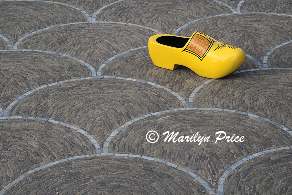 Oversized Dutch wooden shoe with stand of wooden tulips on a patterned patio, Keukenhof Gardens, Netherlands