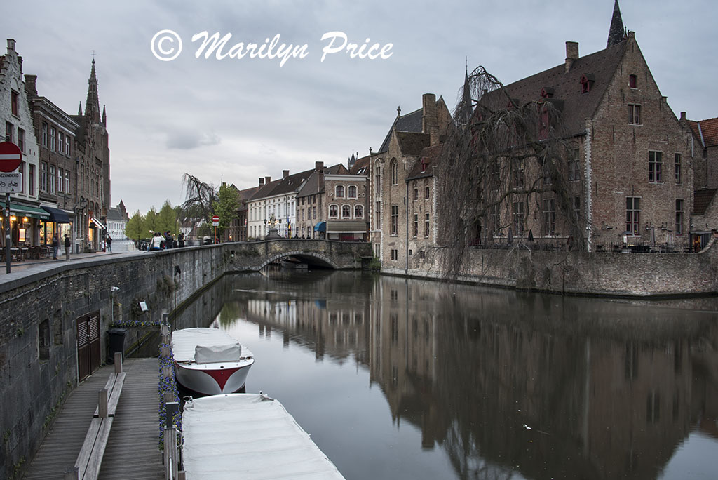 Buildings (including a bridge) reflected in a canal, Bruges, Belgium