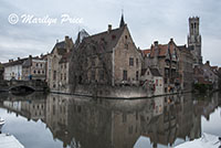 Buildings (including The Belfry) reflected in a canal, Bruges, Belgium