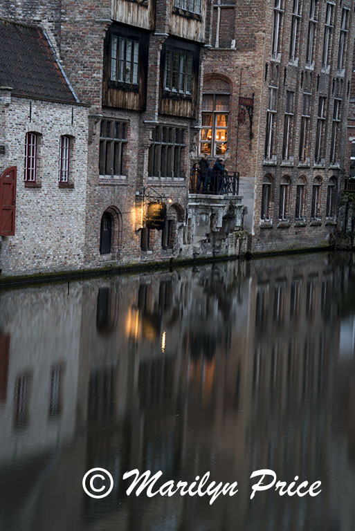 Buildings reflected in a canal, Bruges, Belgium