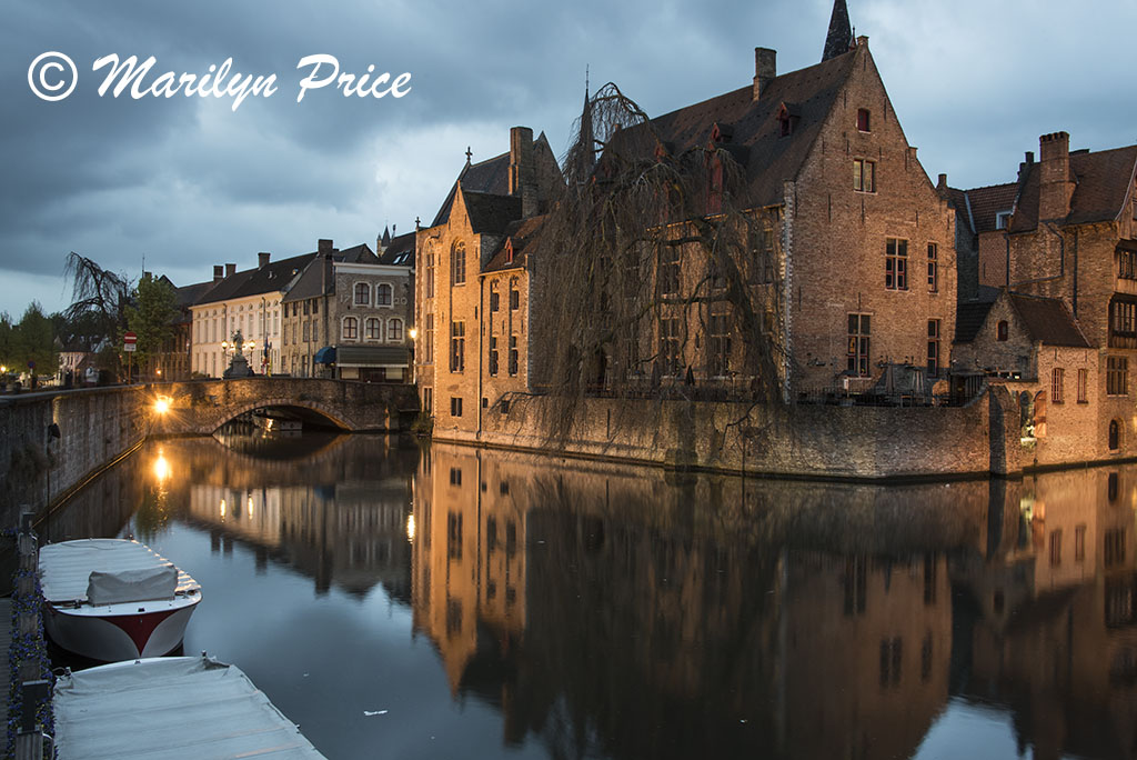 Buildings (including a bridge) reflected in a canal at twilight, Bruges, Belgium