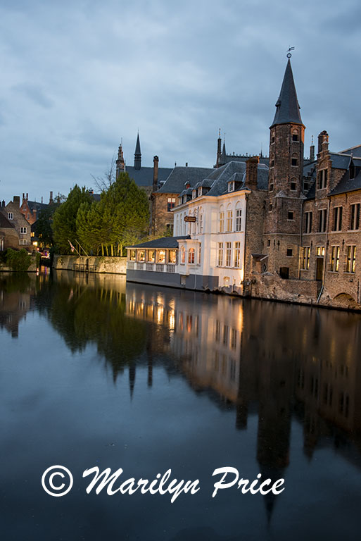 Buildings reflected in a canal at twilight, Bruges, Belgium