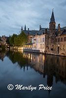 Buildings reflected in a canal at twilight, Bruges, Belgium
