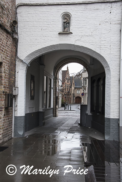 Street through an arched alley, Bruges, Belgium
