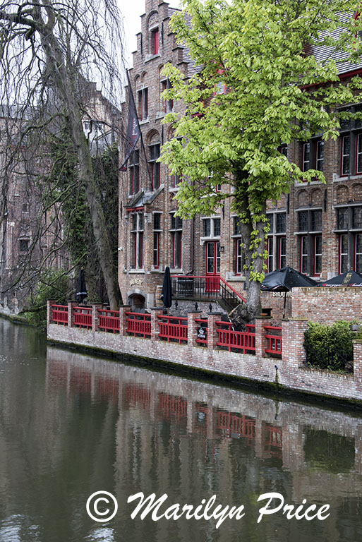 Outdoor restaurant (Bourgognedes Brewery) reflected in a canal, Bruges, Belgium
