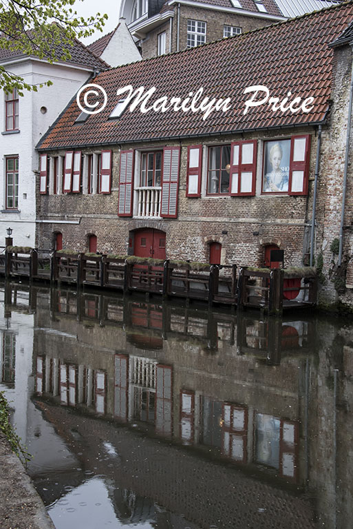 Building reflected in a canal, Bruges, Belgium