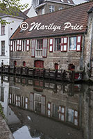 Building reflected in a canal, Bruges, Belgium