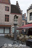 Small courtyard with a statue and an outdoor restaurant, Bruges, Belgium