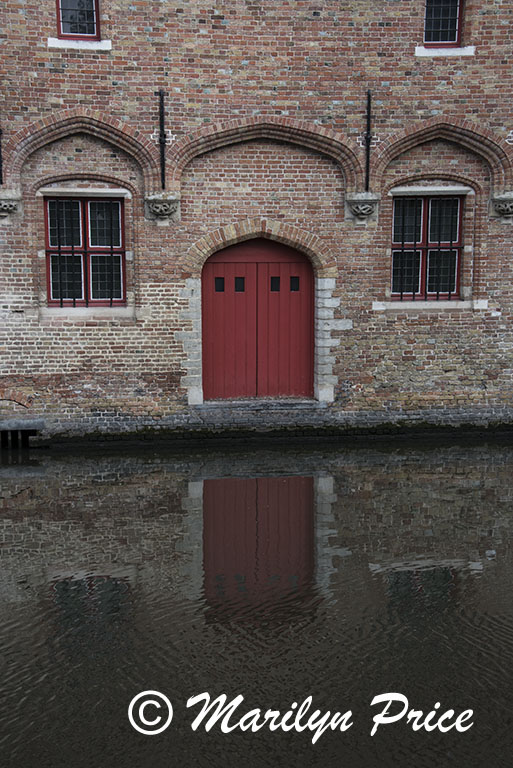 Door reflected in a canal, Bruges, Belgium