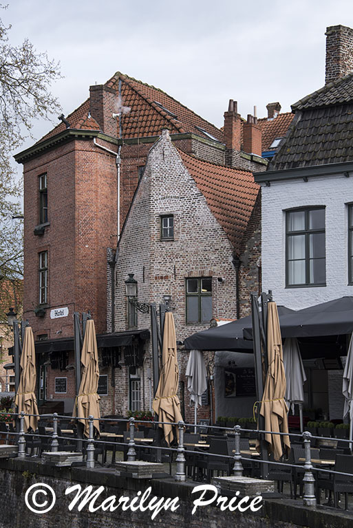 Folded umbrellas at an outdoor restaurant, Bruges, Belgium