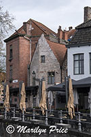 Folded umbrellas at an outdoor restaurant, Bruges, Belgium
