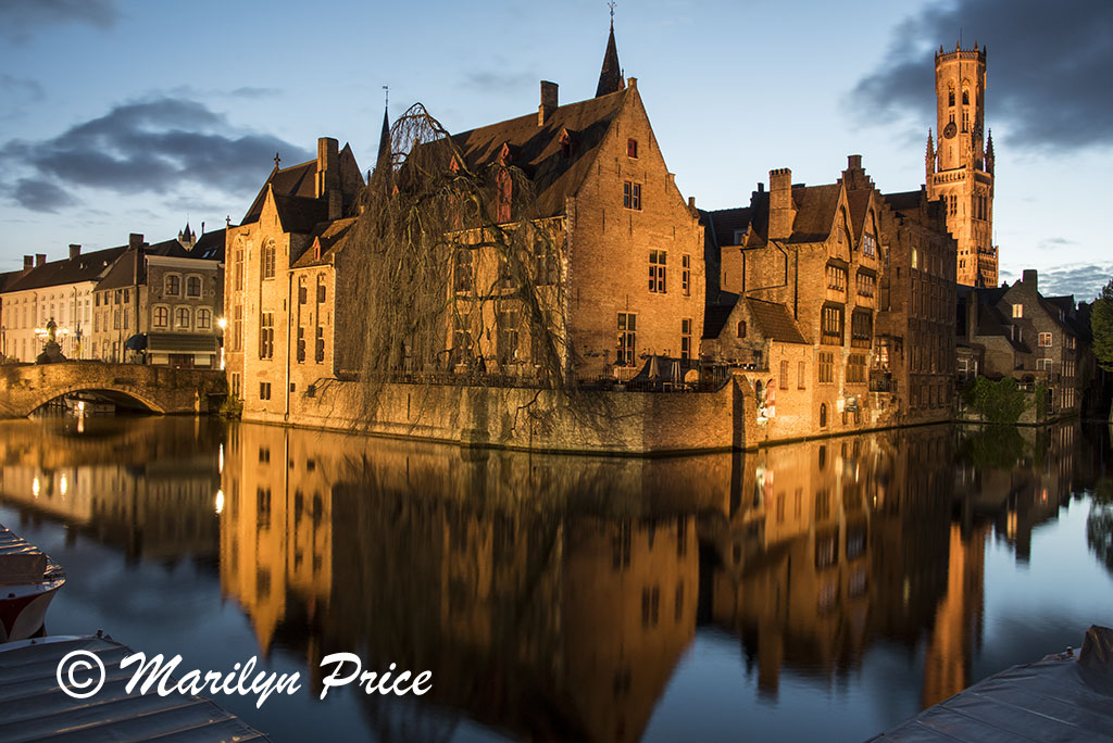 Buildings reflected in a canal with The Belfry (twilight), Bruges, Belgium