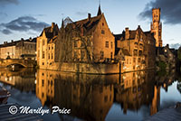 Buildings reflected in a canal with The Belfry (twilight), Bruges, Belgium