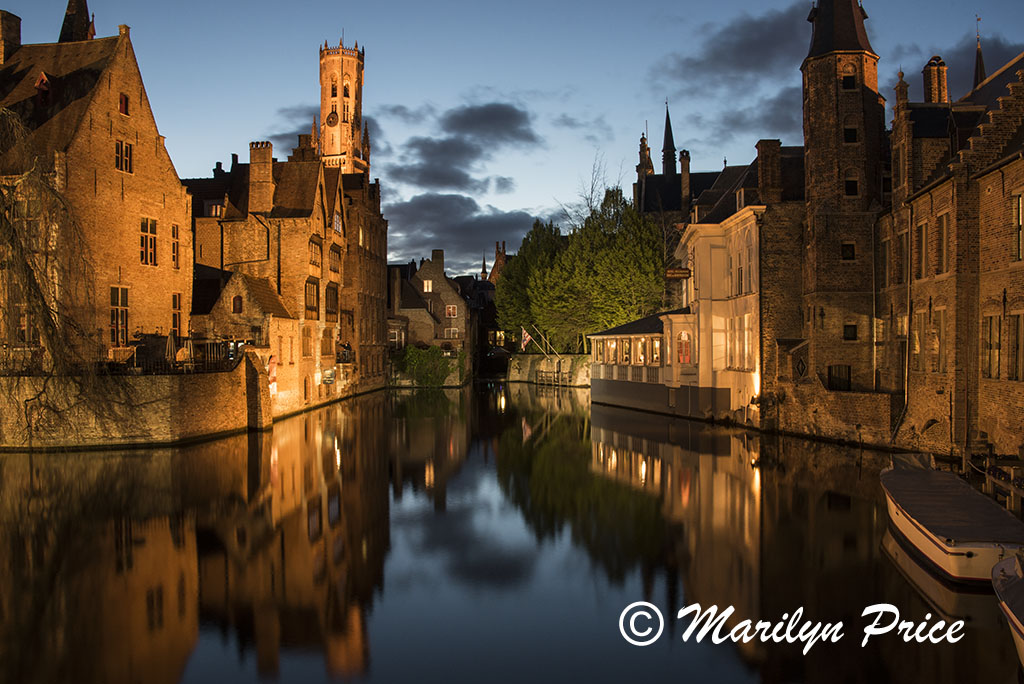 Buildings reflected in a canal with The Belfry (twilight), Bruges, Belgium