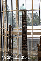 Totem poles in the Royal British Columbia Museum with provincial buildings in background, Victoria, BC, Canada