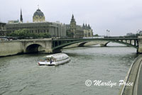 A tour boat on the Seine passes near the Conciergerie, Paris, France
