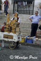 An organ grinder entertains in front of Sacre Coeur, Paris, France