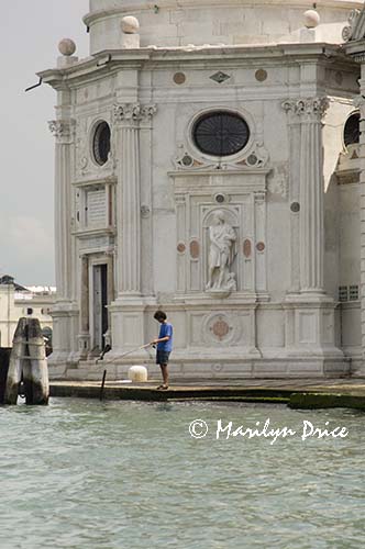 Fisherman in front of San Michele in Insola, Venice, Italy