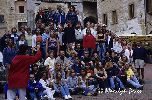 A chorus from Nebraska sings at the town well, San Gimignano, Italy