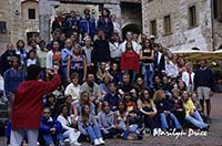 A chorus from Nebraska sings at the town well, San Gimignano, Italy