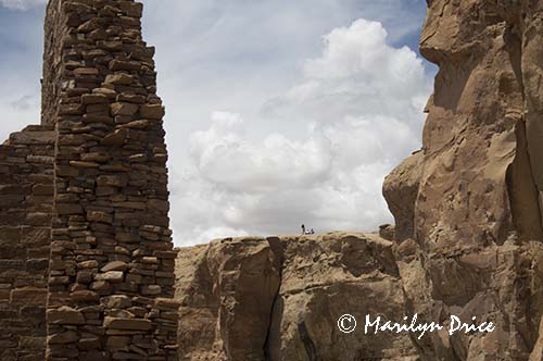 Hikers on the cliffs above Pueblo Bonita, Chaco Culture National Historic Park, NM