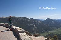 A bicyclists takes a break at Rainbow Curve, Rocky Mountain National Park, CO