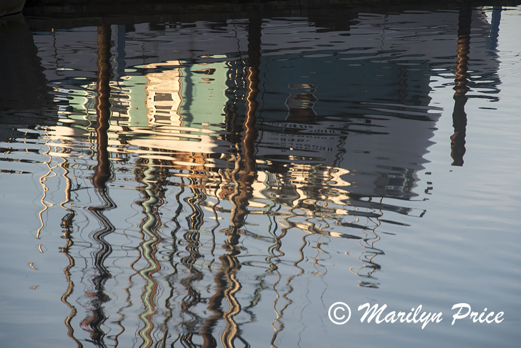 Reflections of a fishing boat, Yaquina Bay harbor, Newport, OR