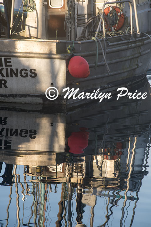 Reflections of a fishing boat, Yaquina Bay harbor, Newport, OR