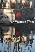 Reflections of a fishing boat, Yaquina Bay harbor, Newport, OR