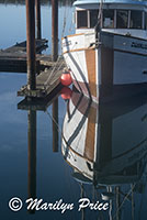 Reflections of a fishing boat, Yaquina Bay harbor, Newport, OR