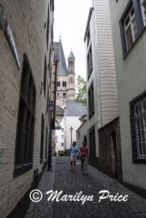 Narrow street and oldest church (Great St. Martin) Cologne, Germany