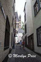 Narrow street and oldest church (Great St. Martin) Cologne, Germany