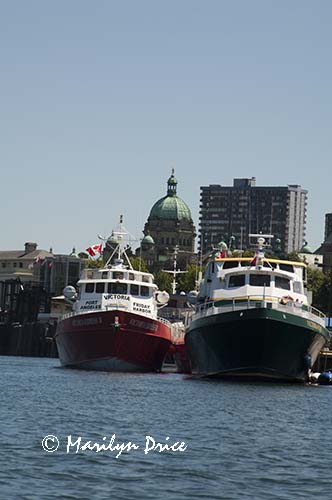 British Columbia Parliament Building towers over the boats of the inner harbor, Victoria, BC