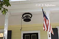 Bell and US flag at Key West's first school house, Key West, FL