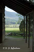 Looking over the valley of Cades Cove through the porch of the John Oliver Place, Cades Cove, Great Smoky Mountains National Park, TN